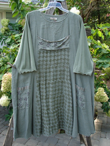 Barclay Cotton Sleeve Upper Pocket Dress Tiny Floral Moss Size 2, hanging on a tree branch, showcasing its A-line flair, sectional panels, and three-quarter length sleeves.