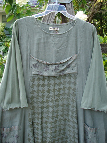 Barclay Cotton Sleeve Upper Pocket Dress Tiny Floral Moss Size 2 displayed on a hanger, showcasing its A-line flair, rounded neckline, sectional panels, horizontal upper bodice pocket, and drawcord back.