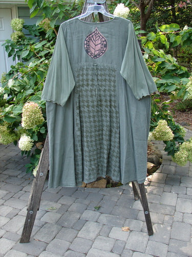 Barclay Cotton Sleeve Upper Pocket Dress Tiny Floral Moss Size 2 displayed on a wooden stand, showcasing its A-line flair, rounded neckline, and sectional panels.