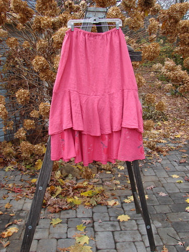 Barclay Linen Two Tier Ruffle Skirt Tiny Dragonfly Peony Size 2 displayed on a wooden stand, showcasing its flowing double A-line design and intricate ruffled layers.