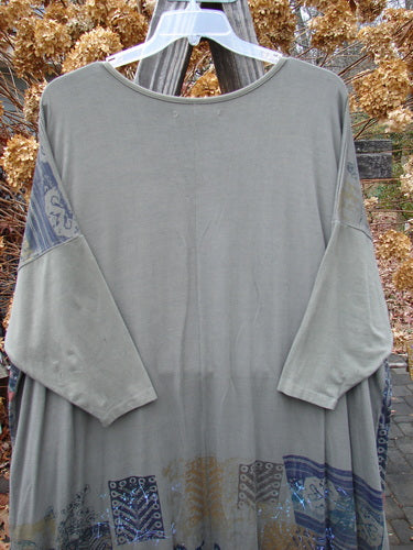 Barclay Bamboo Big Square Pocket Dress, featuring a grey shirt on a wooden rack, dolman sleeves, and front drop exterior pockets.