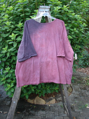 Barclay Center Seam Wide Line Tee Kitty Kitty Date Mottled Rose Berry OSFA displayed on a wooden stand, showcasing its rounded neckline, drop shoulders, and wide boxy shape with a central seam.