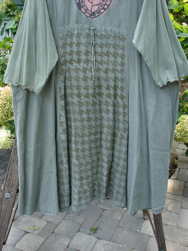 Barclay Cotton Sleeve Upper Pocket Dress Tiny Floral Moss Size 2 displayed on a wooden stand, featuring a rounded neckline, three-quarter sleeves, sectional panels, and a horizontal upper bodice pocket.