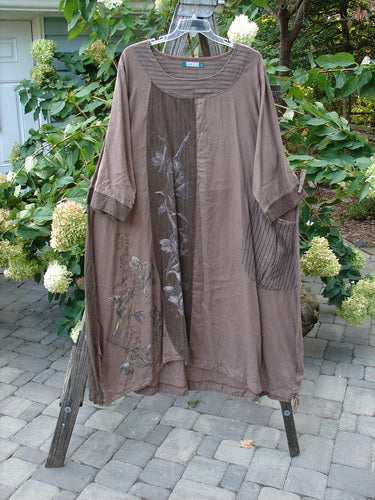 Barclay Linen Gathered Hem Single Pocket Dress Tall Sprig Sand Stone Size 2 displayed on a rack, showcasing its floral design, vertical panels, and three-quarter length sleeves.