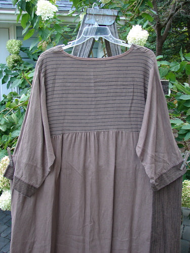 Barclay Linen Gathered Hem Single Pocket Dress Tall Sprig Sand Stone Size 2 displayed on a swing, featuring three-quarter sleeves, a lower hem drawcord, and a generous single-sided drop pocket.