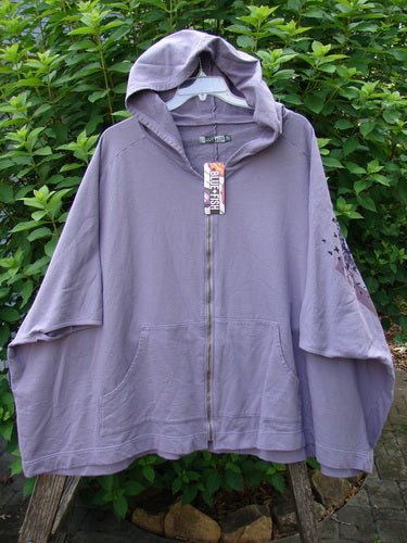 Barclay NWT Hooded Postcard Zipper Jacket Vest Rear Daisy Violet OSFA displayed on a hanger, showcasing its generous hood, full zipper, dolman shoulders, banded bottom, and daisy-themed rear contour design.