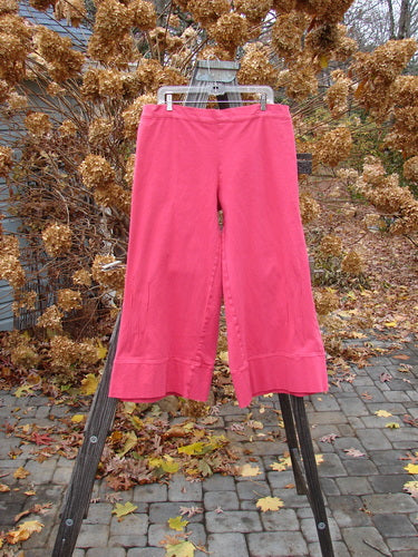 Barclay Heavy Weight Denim Crop Tool Pant Unpainted Tulip Size 2 displayed on a wooden rack, showcasing a lower set elastic waistline and thickly banded lowers.