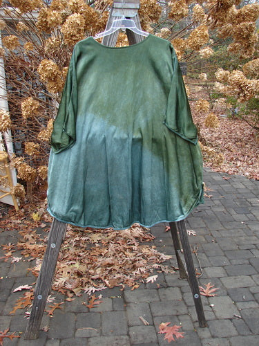 Barclay Viscose Hi Low Tunic Wildflower Forest Sun Size 2 displayed on a rack, showcasing its rounded neckline, three-quarter dolman sleeves, and varying hem.