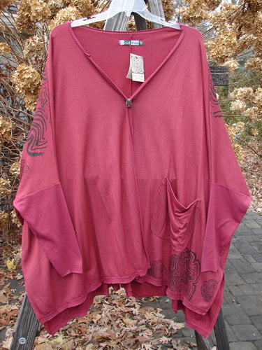 Barclay NWT Rayon Lycra Celebration Cardigan Spirograph Rouge OSFA, featuring an open front, flutter hem, single front pocket, and dolman three-quarter sleeves, displayed on a hanger.
