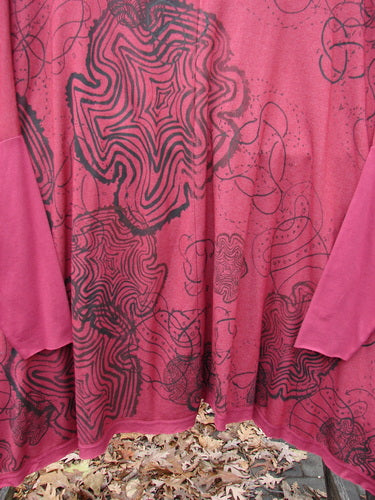 Barclay NWT Rayon Lycra Celebration Cardigan Spirograph Rouge OSFA with an open front, varying hemline, single front pocket, flutter hem, dolman three-quarter sleeves, and spirograph design on the back.