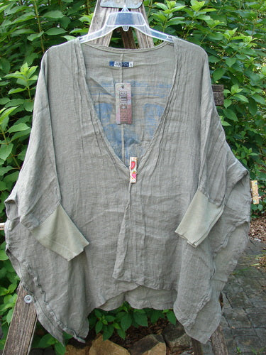 Barclay NWT Linen Open Front Cheerful Crinkle Cardigan displayed on a wooden pole, showcasing dolman sleeves, a vented hemline, and a floral blossom theme, highlighting its free-flowing design.