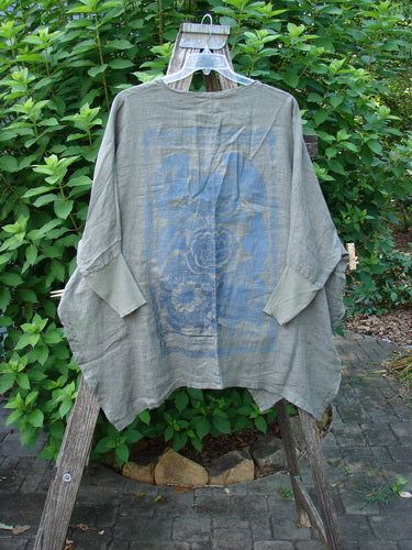 Barclay NWT Linen Open Front Cheerful Crinkle Cardigan on a wooden stand, showcasing dolman sleeves, ribbed cuffs, and a floral blossom theme. Features a square shirttail and vented hemline.