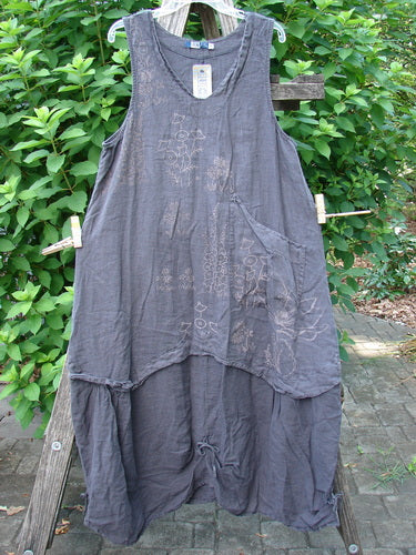 Barclay NWT Linen Explorer Jumper Contour Garden Black Sand Size 0 displayed on a wooden stand, highlighting its unique patterns, scoop neckline, and billowy lower sweep with double loops for gathering.