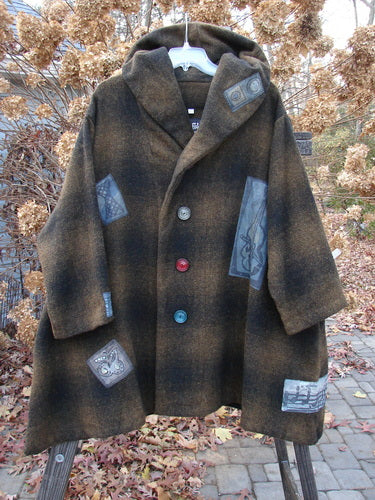 1995 Patched Hooded Autumn Jacket Music Man Cottage Brown Plaid OSFA displayed on a hanger, showcasing oversized vintage buttons, a fold-over collar, deep side pockets, and wide sleeves with foldable cuffs.