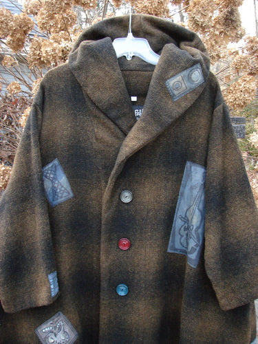 1995 Patched Hooded Autumn Jacket Music Man Cottage Brown Plaid OSFA displayed on a hanger, showcasing oversized buttons, fold-over collar with a large hood, deep side pockets, and wide sleeves.