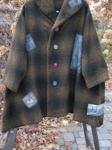 1995 Patched Hooded Autumn Jacket Music Man Cottage Brown Plaid OSFA displayed on a rack, featuring oversized buttons, fold-over collar, lined hood, deep side pockets, and wide sleeves with foldable cuffs.