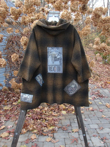1995 Patched Hooded Autumn Jacket Music Man Cottage Brown Plaid OSFA displayed on a stand, showcasing its oversized buttons, deep side pockets, fold-over collar, and numerous patches.