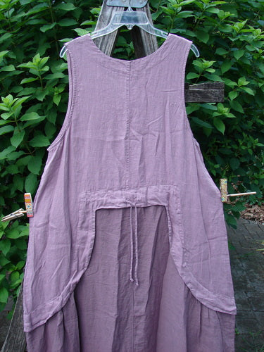 Barclay NWT Linen Explorer Jumper Contour Pansy Patch Tulsi Rose Size 0, featuring a scoop neckline, full A-lined shape, and exterior pocket, displayed outdoors, showcasing its unique design and artistic details.