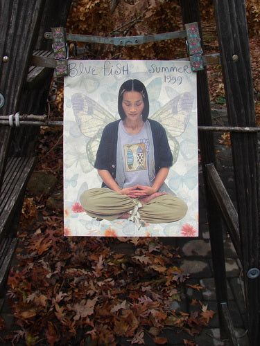 A poster of a girl sitting on a wooden stand, wearing Blue Fish Clothing from the 1999 Summer Catalog. Rediscover vintage pieces and reminisce about the outdoor inspiration.
