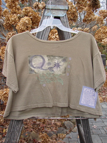 1994 Song Top Garden Bark Size 1 featuring a wide boxy shape, oversized front painted breast pocket, and vintage buttons displayed on a wooden swinger stand.