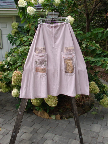1994 PMU Patched Scoop Pocket Skirt Garden Music Pink Granite Size 1 displayed on a rack, featuring a full drawstring waist, scooped painted pockets, and sectional panels for a vintage garden theme.