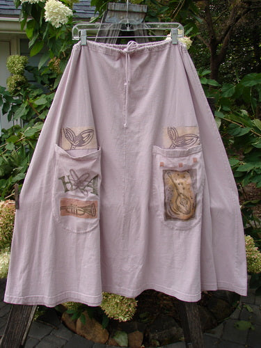 1994 PMU Patched Scoop Pocket Skirt Garden Music Pink Granite Size 1, featuring a drawstring waist, A-line shape, sectional panels, and two scooped pockets with painted garden and fish motifs.