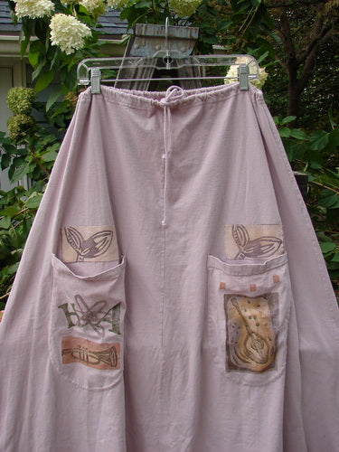 1994 PMU Patched Scoop Pocket Skirt Garden Music Pink Granite Size 1 features a long, pink, A-line skirt with a full drawstring waist, sectional panels, and two front scooped painted pockets.