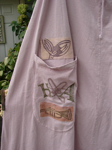 Close-up of the 1994 PMU Patched Scoop Pocket Skirt Garden Music Pink Granite Size 1, showcasing the intricate painted garden and fish theme on medium-weight cotton jersey with scooped pockets and sectional panels.