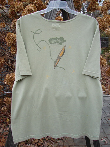 2001 Short Sleeved Tee Glider Plane Kelp Size 1 featuring a drawing of a glider plane, drop shoulders, wide short sleeves, and a slightly thinner flattened neckline.
