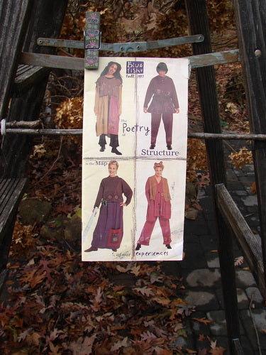 1997 Fall Catalog Our Experiences One Size: a poster on a metal frame featuring a collage of women's clothes, a woman in a purple dress, a person wearing a black coat, and a person wearing a red outfit.