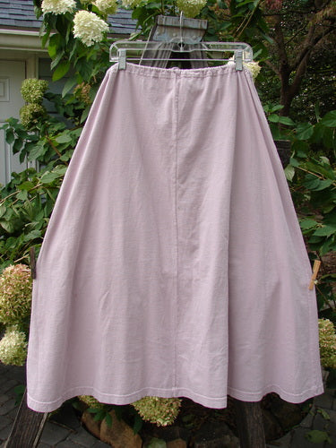 1994 PMU Patched Scoop Pocket Skirt Garden Music Pink Granite Size 1, displayed hanging on a clothesline, showcasing its full drawstring waist, sweeping A-line shape, and two front scooped painted pockets.