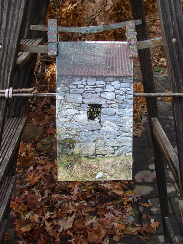 Alt text: "2000 Fall Catalog A Celtic Journey One Size: Stone house with a hole in the wall, leaves on the ground, and a close-up of a bench - outdoor, autumn, plant, fall, wood"