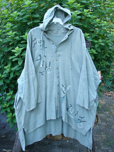 1997 Linen Seaspray Jacket Bamboo Lagoon Size 3, featuring a floppy drawcord hood, generous shirttail hemline, dolman sleeves, and metal buttons with bamboo theme, seamlessly combines vintage charm with unique design elements.