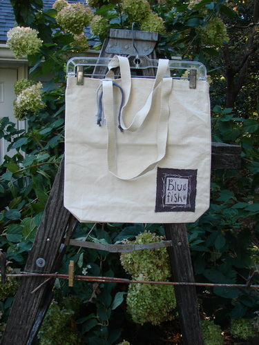 1998 PMU Patched Organic Cotton Canvas Tote Bag Oak Leaf Natural One Size displayed hanging on a wooden ladder, highlighting its tightly woven tote straps and oak leaf patch decoration.