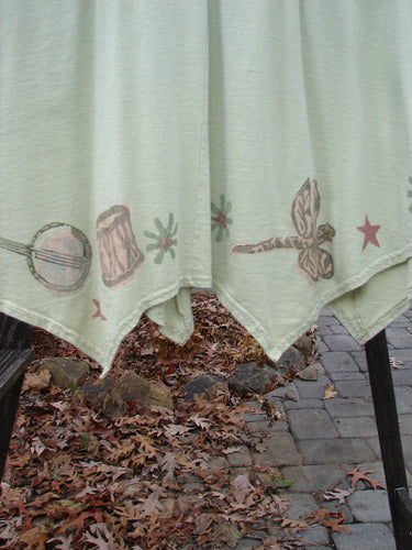 Image alt text: "1994 Leaf Top Music Garden Aloe Size 2: Tablecloth with drawings, close-up of curtain, dragonfly on fabric, close-up of guitar"