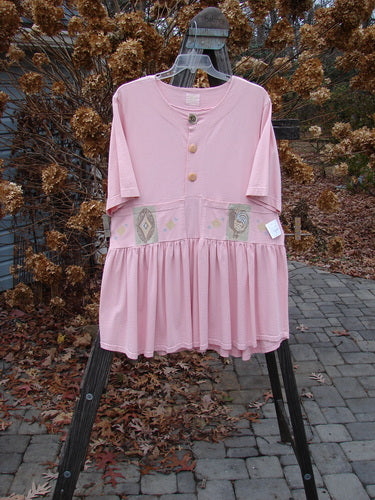 1999 NWT Garden Herb Dress Rooster Peony Size 1 displayed on a rack, showcasing a drop waistline, four-paneled pockets, and a flirty varying hemline, ideal for vintage fashion enthusiasts.