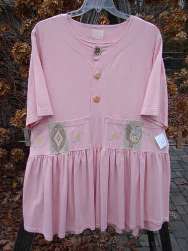 1999 NWT Garden Herb Dress Rooster Peony Size 1 featuring a pink fabric with button details and a rooster design, drop waistline, four-paneled pocket, and varying hemline.