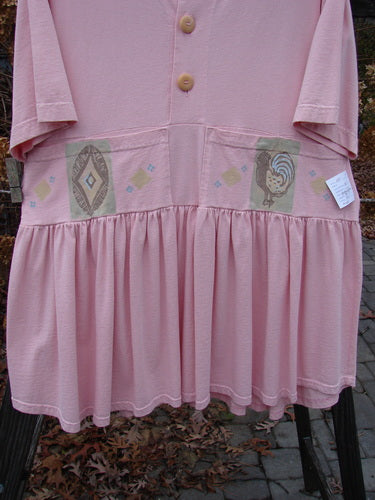 1999 NWT Garden Herb Dress Rooster Peony Size 1, featuring a pink dress with a rooster design, four paneled pockets, drop waistline, ceramic top button, and a flirty varying hemline.