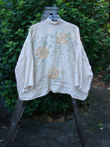 Magnolia Pearl Linen Embroidered Claudio Kimono Lilac Water OSFA features pastel floral embroidery on medium-weight linen, with an open front, dolman shoulders, and wide three-quarter sleeves, reflecting Bluefishfinder.com's vintage style.
