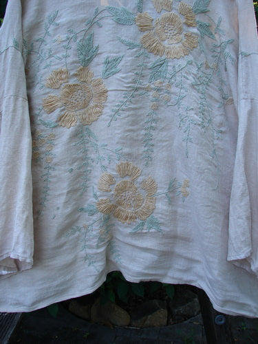 Magnolia Pearl Linen Embroidered Claudio Kimono Lilac Water OSFA features intricate pastel floral embroidery, a widening shape, stand-up collar, and wide three-quarter sleeves, reflecting Bluefishfinder.com's vintage-inspired, expressive fashion ethos.