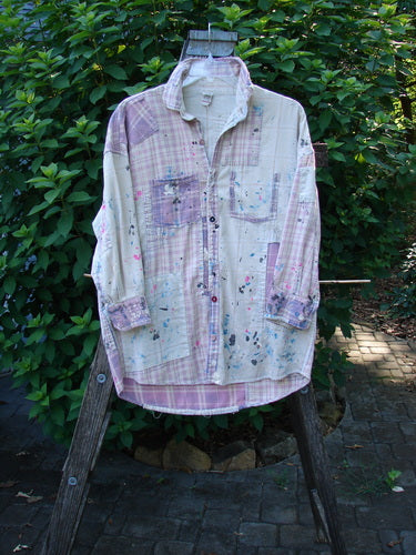 Magnolia Pearl Flannel Patched Surfside Shirt Sun Bleached OSFA features hand distressing, generous patching, long sleeves with button cuffs, and a unique hemline, showcasing artistic detailing and craftsmanship.