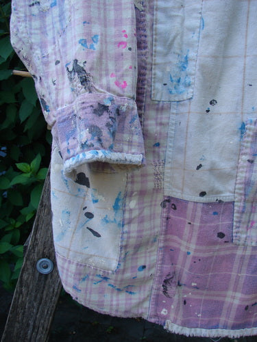 Magnolia Pearl Flannel Patched Surfside Shirt Sun Bleached OSFA featuring hand-distressed patchwork, paint splatters, button cuffs, a single breast pocket, and unique rear patch emblem, reflecting BlueFishFinder's creative individuality.