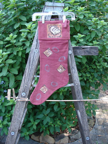 1995 Reprocessed Holiday Stocking Festive Hollyberry OSFA: A rare vintage stocking featuring a striking blue fish design, displayed against a ladder in a garden setting, perfect for collectors and holiday enthusiasts.