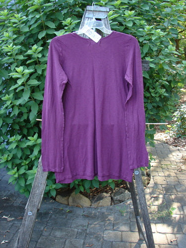 Barclay NWT Slub Cotton Hemp Long Sleeved Simple Tee Crystal Tyrian Berry Size 1 displayed on a wooden rack, highlighting its rounded neckline and full-length sleeves, embodying Bluefishfinder.com's vintage aesthetic.