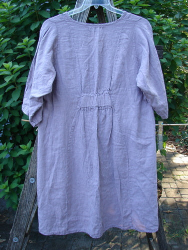 Barclay NWT Linen Posey Tunic Dress Orchid Field Sea Fog Size 0 on a rack; features oval neckline, flowy figure-eight shape, nearly three-quarter sleeves, and two drop front pockets.