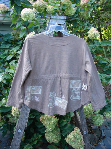 1999 Coffee Top Fancy Pot Riverbed Size 1 featuring a rounded hemline, big button closures, and a drawcord back with a flowerpot theme design, showcasing Blue Fish's vintage style.