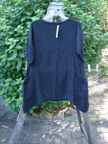 Barclay NWT Gauze Seaside Tunic Dress Unpainted Black Size 0 displayed on a wooden rack, showcasing drop shoulders, wide short sleeves, and a varying hemline, embodying BlueFishFinder's vintage, creative style.