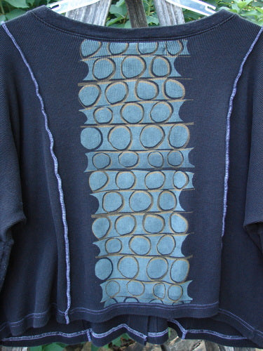 Barclay Thermal Exterior Stitch Two Pocket Jacket in black, featuring a rounded neckline, long narrowing sleeves, double drop painted pockets, and vertical exterior stitchery in a geos theme, showcasing its vintage Blue Fish Clothing style.