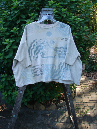 Barclay Hemp Cotton Banded Sleeve Colors Sweatshirt Elements Cloud OSFA displayed on a wooden swing, showcasing its wide, boxy shape, rounded neckline, and contrasting textured hemp side panels, embodying cozy fall fashion.