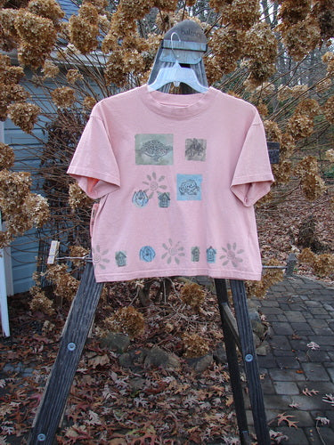 1994 NWT Short Sleeved Tee Garden Critter Seashell Size 3 displayed on a swing, showcasing its cropped shape, wide ribbed neckline, and signature Blue Fish Poetry Patch.
